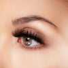 Side close up view of woman wearing Emma Natural Strip Lashes