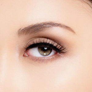 open eye close up of woman wearing wispy eyelashes